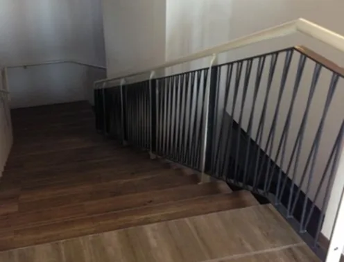 Steel bar staircase railing with timber handrail